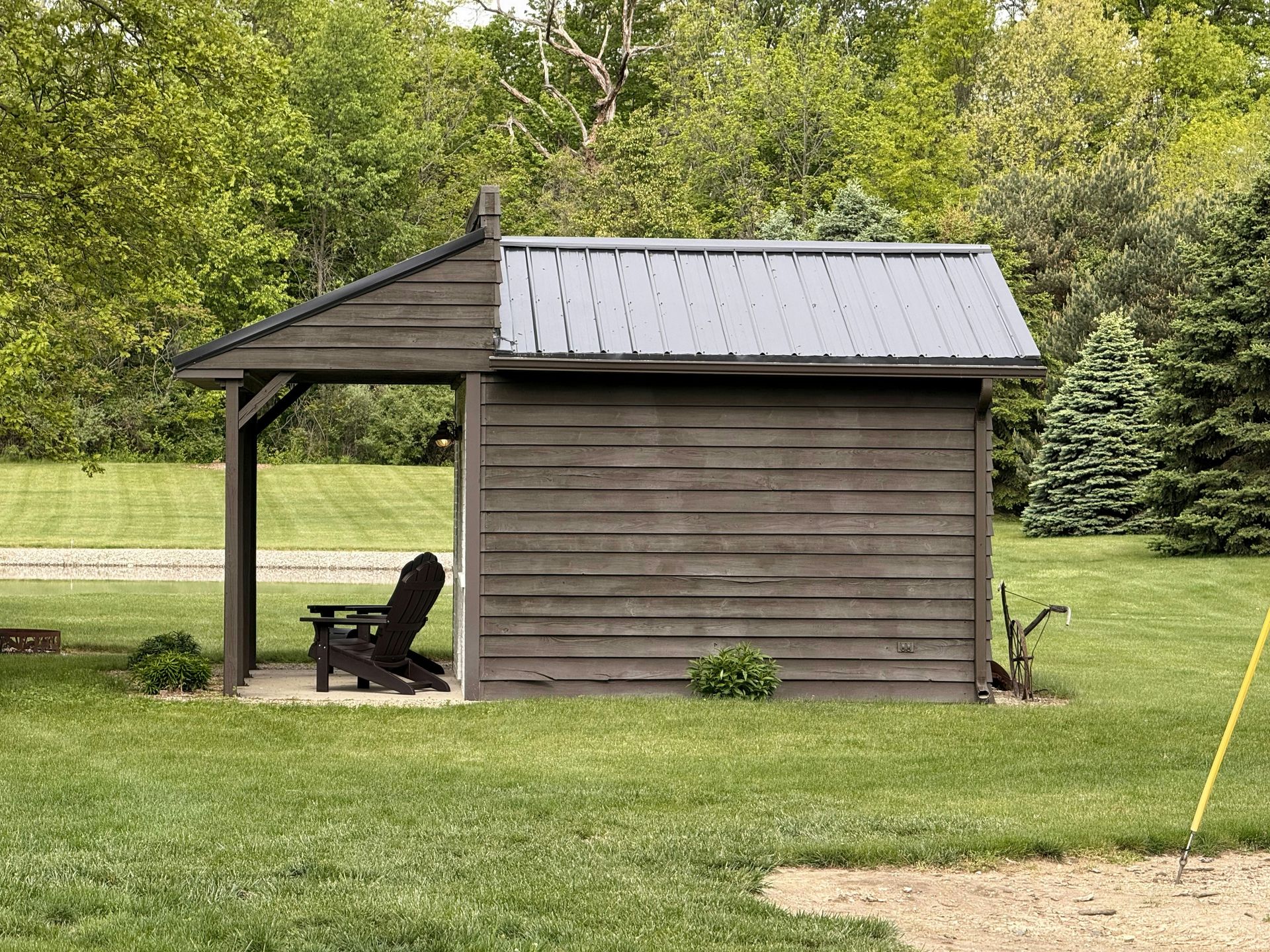 Wooden shed with an open covered seating area